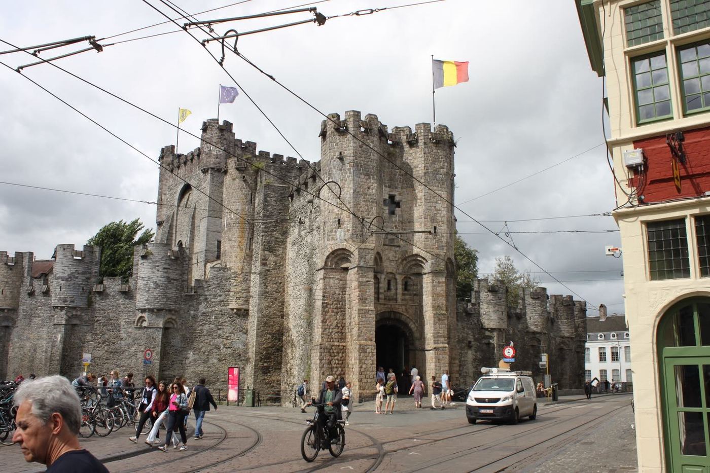 A medieval castle gate on a busy street